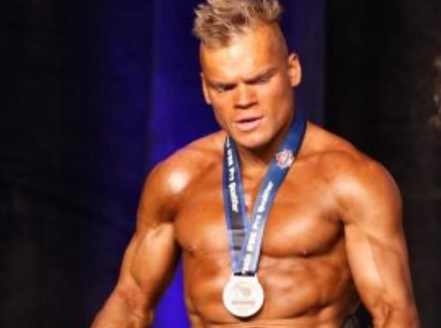 Bray onstage wearing a competition medal.